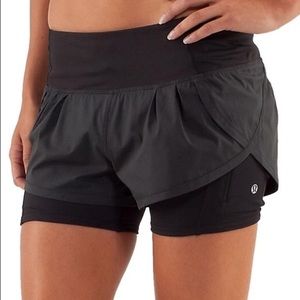 Lululemon black run speed squat shorts layered.